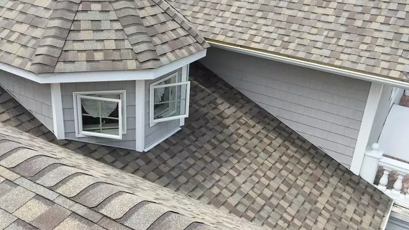 CertainTeed offers its Landmark shingles in the Weathered Wood color, which provides a warm, natural wood-tone appearance with blended browns and grays. 